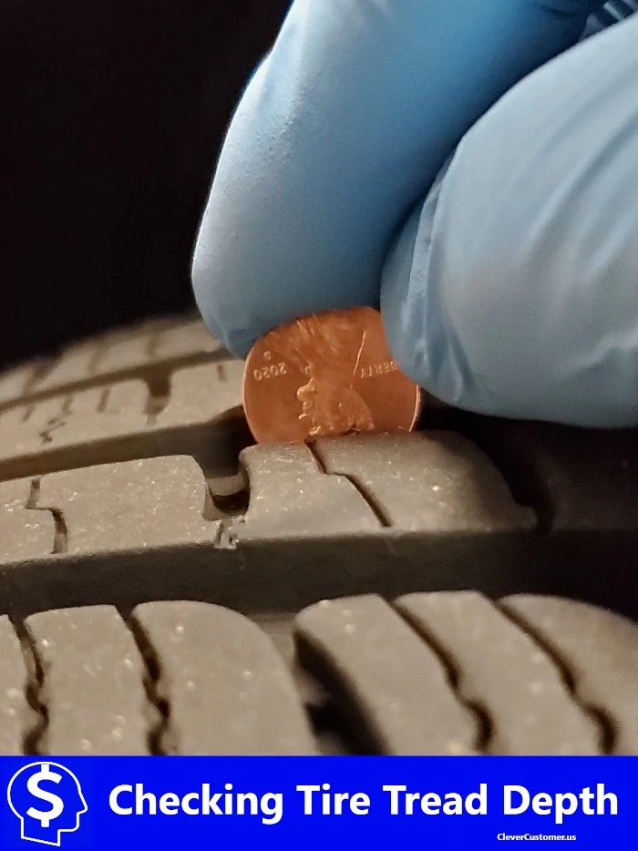 Inspecting Used car tire tread depth with a coin